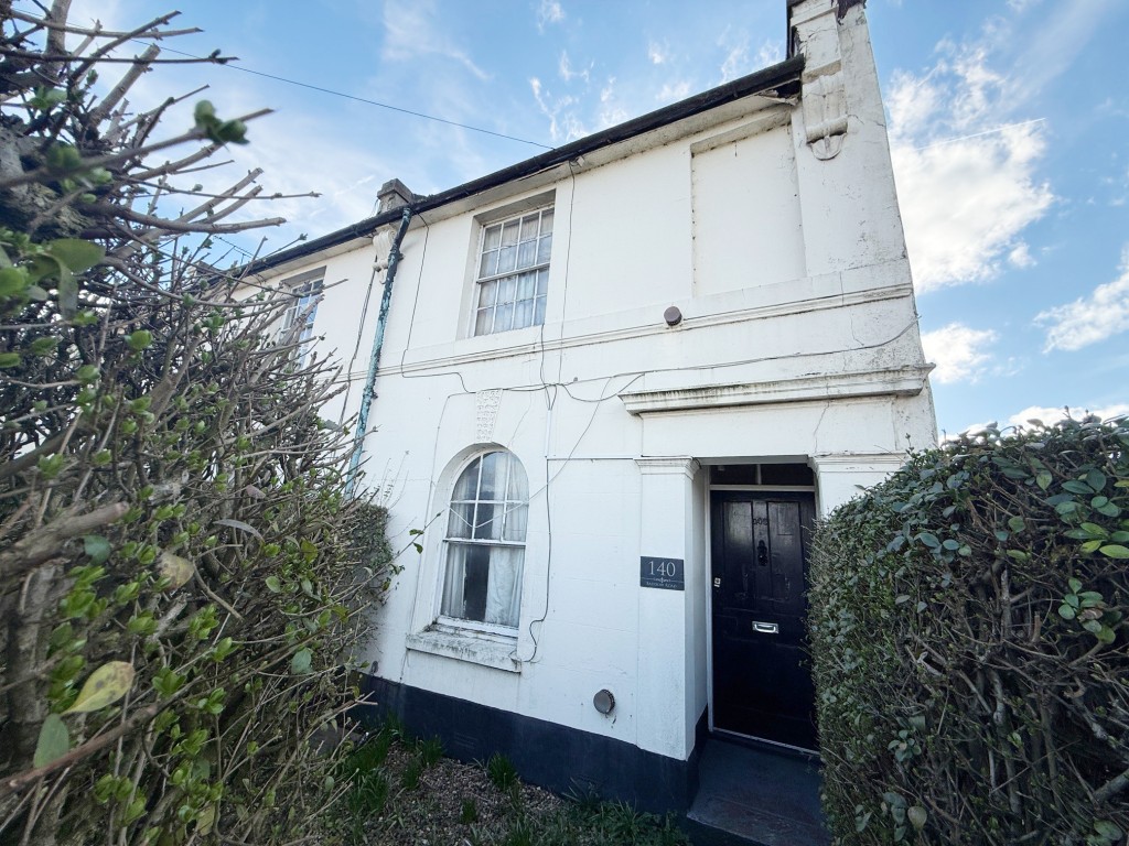 Lot: 11 - END-TERRACE HOUSE FOR IMPROVEMENT - Front of the end terrace house close to the Army and Navy